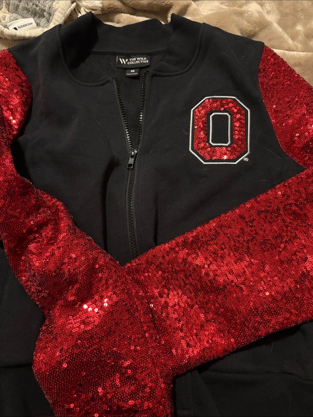 The Wild Collective Black Zip Jacket with Red Sequin Sleeves and Patch